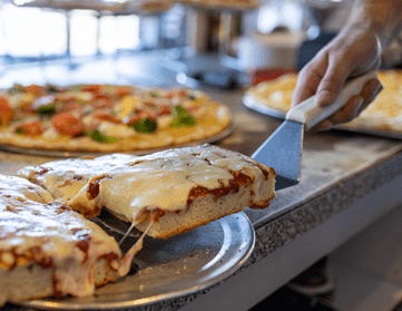 grandma slice of pizza on a silver spatula